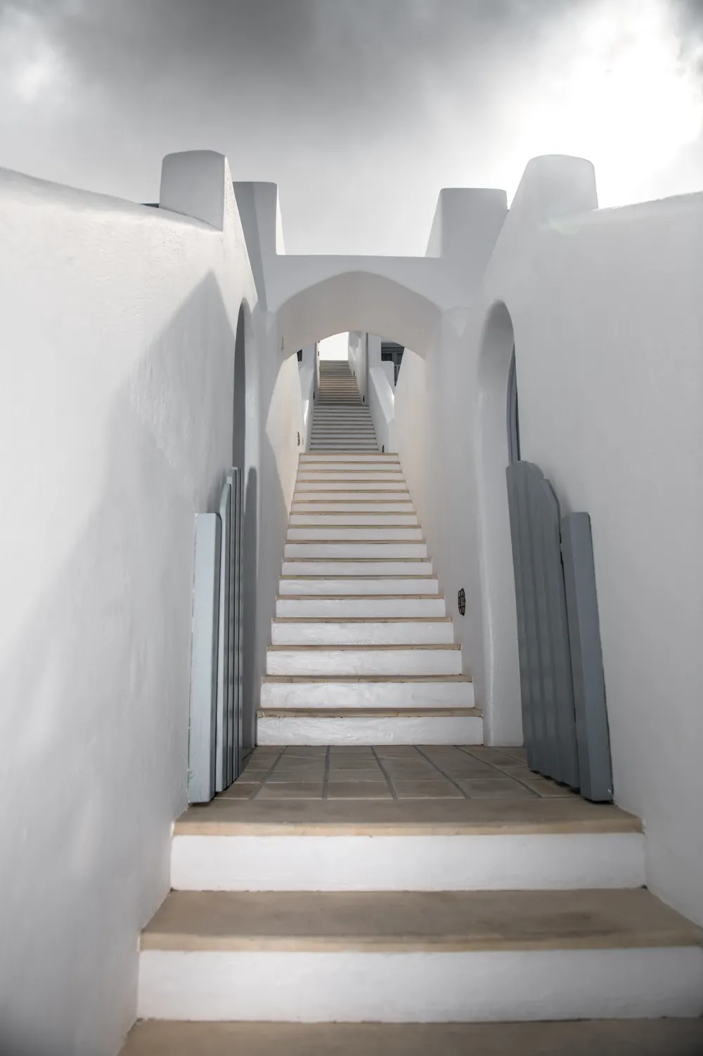 A narrow whitewashed staircase cut into island stone