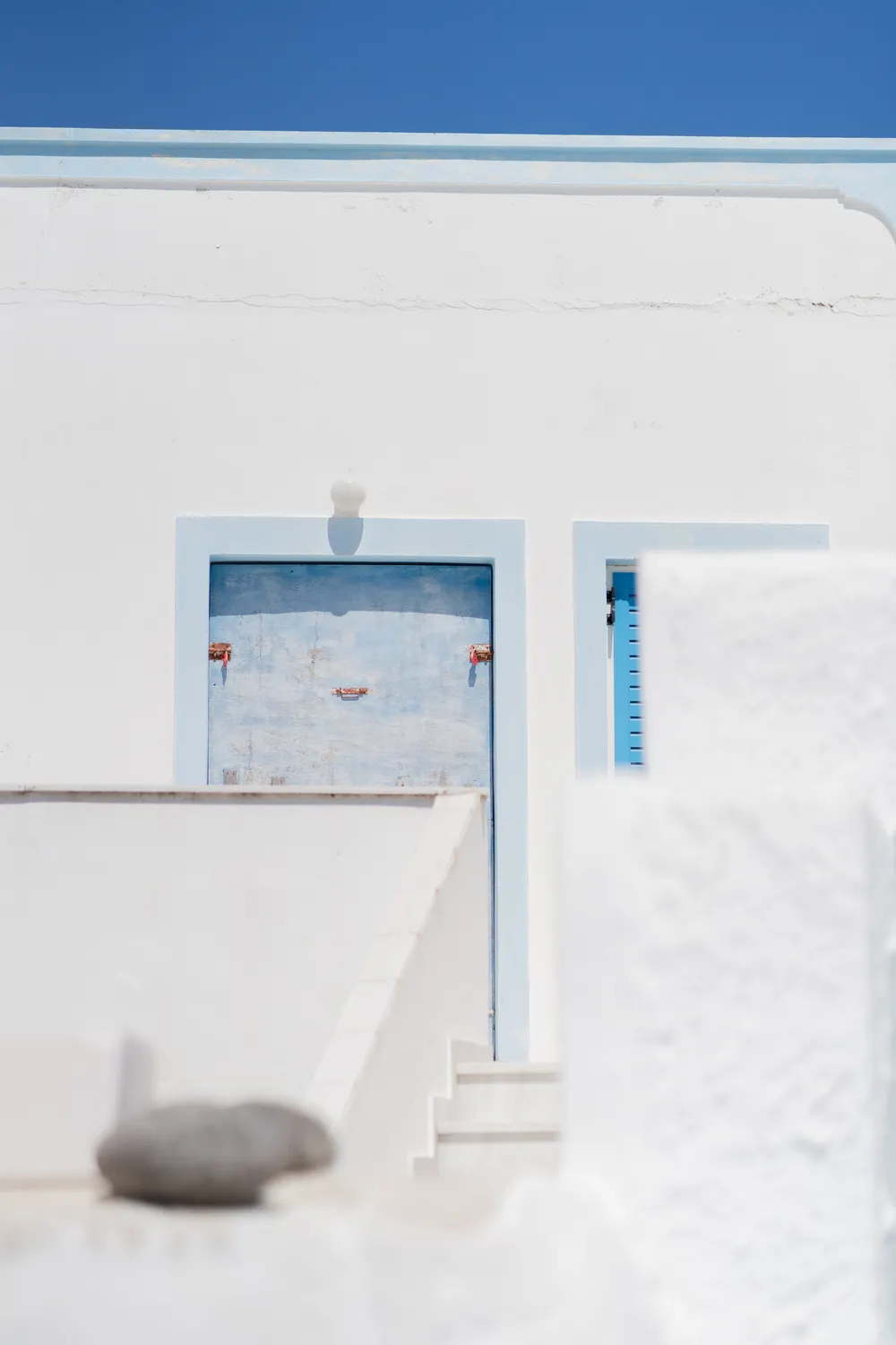 Whitewashed Cycladic walls under a bare sky