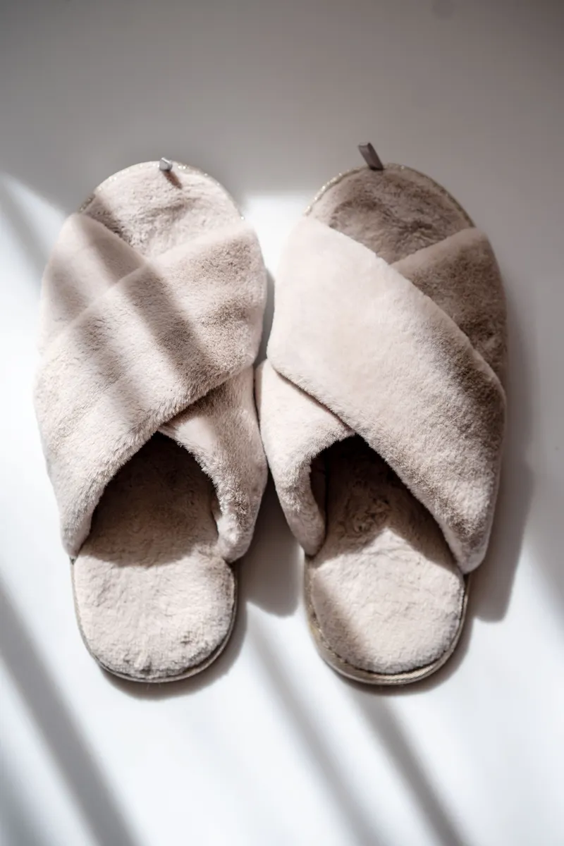 Two soft slippers casting long shadows in low sun